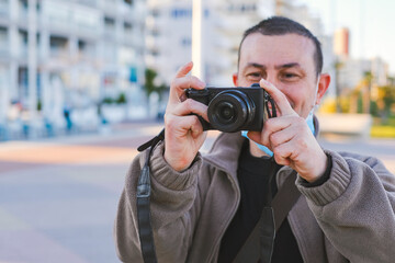 Man having fun taking pictures with a professional reflex camera.