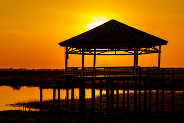 Dry or arid lake and old vintage pavilion with sunset light on the evening.