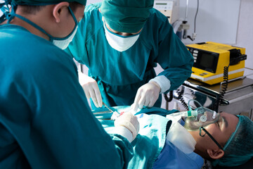 Selective focus at defibrillator while doctor use it to pump at chest of unconscious with low heart rate patient to save life while doing medical surgery inside of operating room. Emergency aid, CPR.