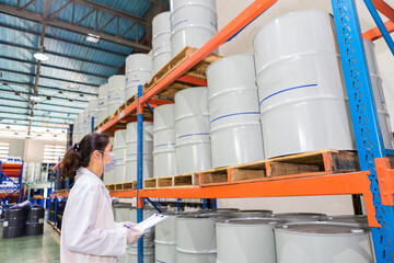 Employees inspecting industrial oil tanks in a warehouse, Infrastructure.