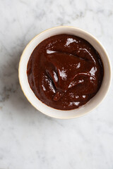Top view of BBQ sauce in a white small container