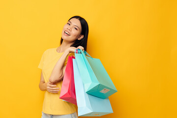 Fototapeta na wymiar pretty brunette woman with packages in hands shopping isolated background unaltered