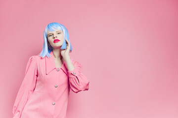 fashionable woman in blue wig pink dress red lips isolated background