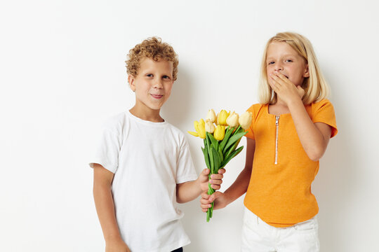 picture of positive boy and girl fun birthday gift surprise bouquet of flowers lifestyle unaltered