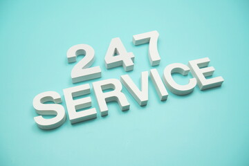 24/7 Service alphabet letters on blue background