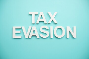 Tax Evasion Word alphabet letters on blue background