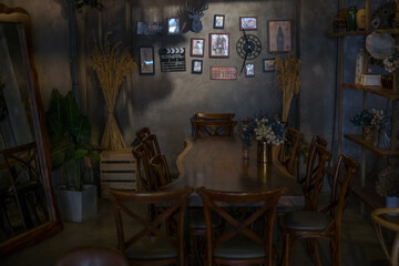 Eco cafe design in brown. Chandeliers made of rope. Antique items on the wall. Solid wood furniture. flower bouquets. High quality photo