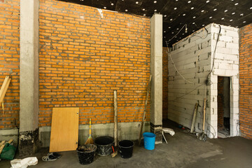 Newly renovated generic empty office space with leftover materials and ladder in foreground