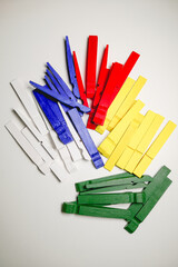 clothespins are disassembled and painted white, red, blue and green