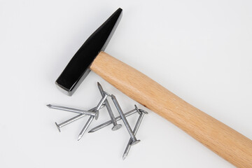 hammer and metal construction nails on a white background.