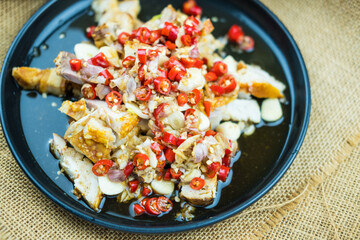 Crispy pork dressing with lime garlic and chili sauce salad on plate