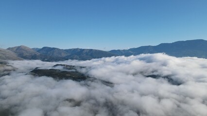 Fototapeta premium defauAerial View Massive Clouds Of Fog Above The valley Of Koritiani Village In thesprotia, Epirus, Greecelt