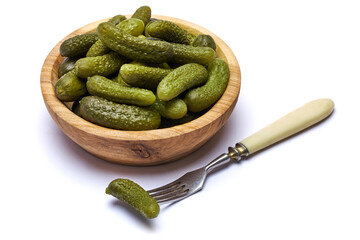 Bowl of Tasty canned Whole green cornichons isolated on a white background