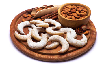 German or Austrian Vanillekipferl vanilla kipferl cookies and almond nuts on wooden serving board