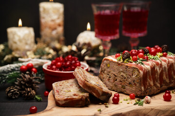Fototapeta na wymiar Traditional French terrine covered with bacon on dark wooden background with Christmas decorations