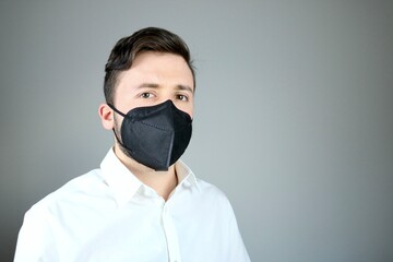 Young elegant man wearing black ffp2 Hygienic Mask 