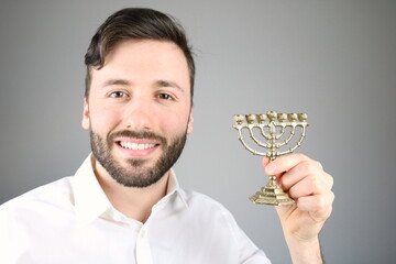 Caucasian man holding little jewish candlestick