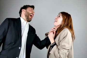 Aggressive businessman is holding a girl's neck