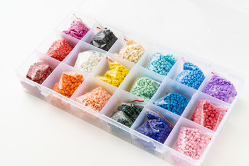 set for creativity and needlework. colorful beads in the box with cells. Convenient storage of beads.