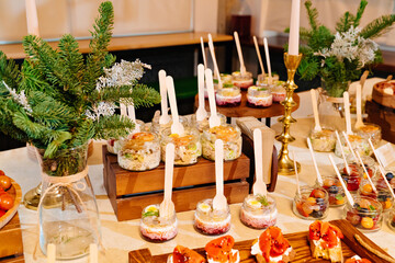 convenient portioned serving of salads in small jars and canapes. beautiful original table setting for banquet. Catering. 