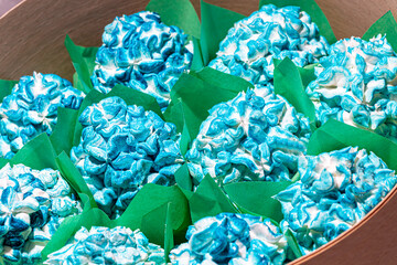 Handmade marshmallows in wooden packages on a light background with flowers. The concept of the...