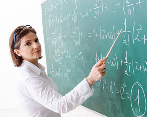 The female math teacher in front of the chalkboard