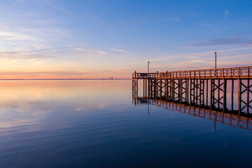 Fototapeta na wymiar Mobile Bay pier at sunset in January of 2022