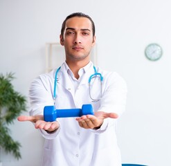 Young male doctor in sport and dieting concept