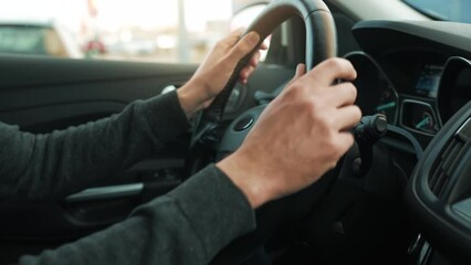 Man driving car through a parking and is looking for a place to park and drives into it