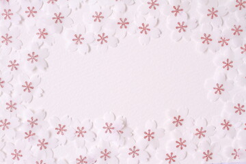 Cherry blossom petal paper crafts on white textured paper background for wall paper.  Blank for copy space.