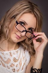 portrait of a young woman with glasses in a photo studio