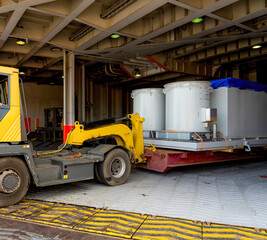 discharging a big mafi from a roro vessel with a tug master - obrazy, fototapety, plakaty