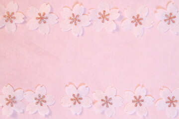 Cherry blossom petals paper crafts on pink textured paper background for wall paper.  Blank for copy space.