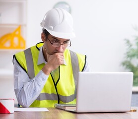 Young male architect working in the office