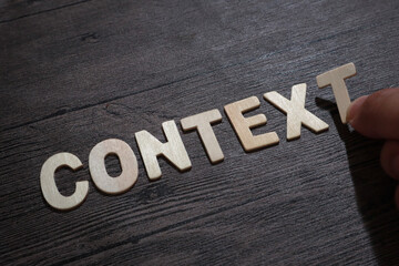 Context, text words typography written with wooden letter on black background, life and business motivational inspirational