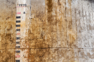 Scale for rising water on a concrete surface. Waterline. Measuring scale. Spring floods. Exceeding...