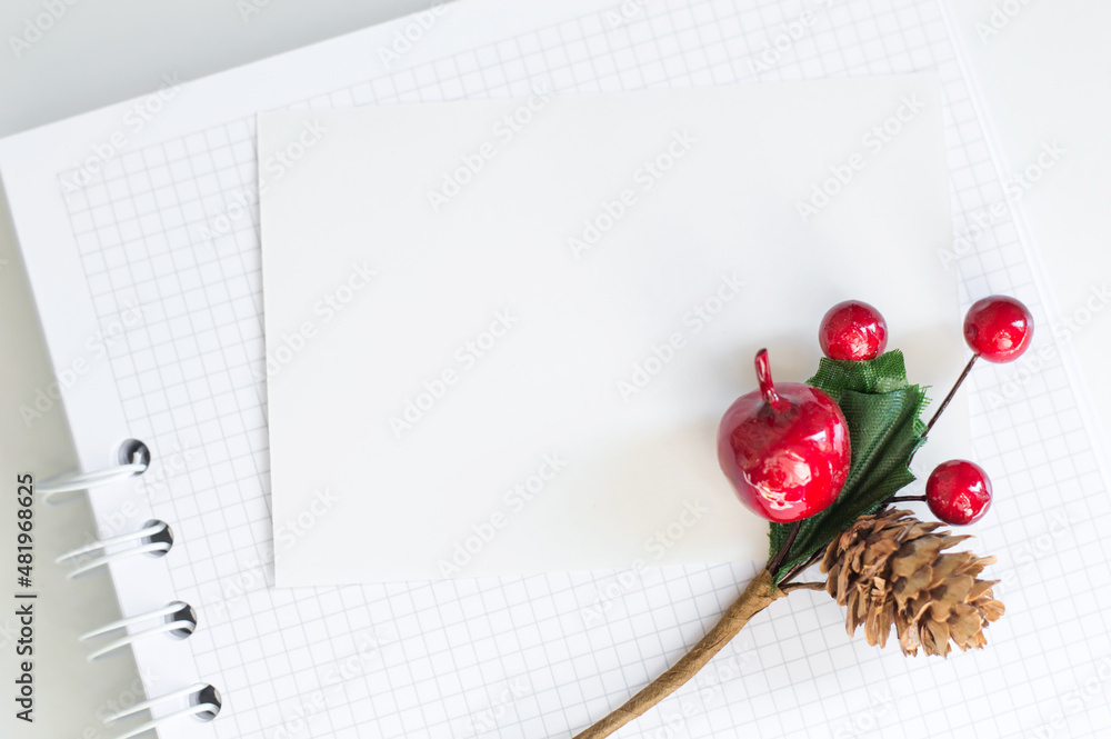 Aufkleber a blank card for text on a white notepad on a table next to a decorative branch