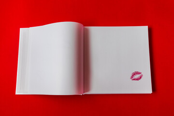  Imprint of female lips on white paper on a red background. kiss on paper. Love message. High quality photo