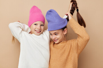 two little girls are standing next to each other in hats fashion emotions