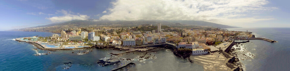 Fototapeta premium Aerial panoramic view of Santiago del Teide landscape with homes and pools in Tenerife from drone.