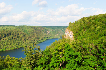Fototapeta na wymiar Beautiful river on forest background and blue sky