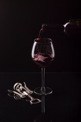 glass goblet of red wine on a black background