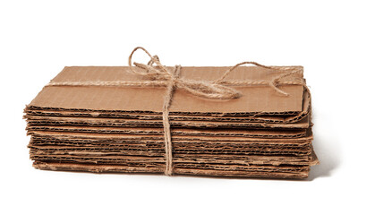 Tied pile of corrugated fiberboard ready for recycling isolated on a white background. Waste paper 