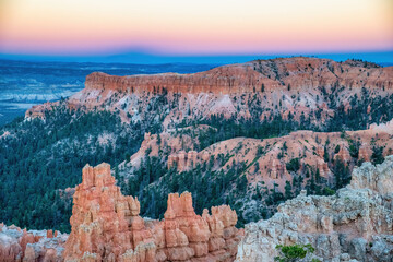 Aerial view of Bryce Canyon at summer sunset. Overlook of orange colorful hoodoos red rock...