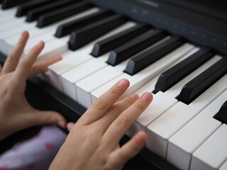 Close-up of a child's hand playing the piano . Favorite classical music. musical instruments for teaching music at home. The concept of a musical instrument. Self-education.