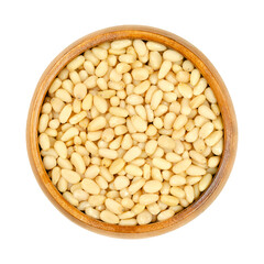 Cedar nuts, pine nuts, harvested in Russia, in a wooden bowl. Edible seeds of Siberian pine, Pinus...