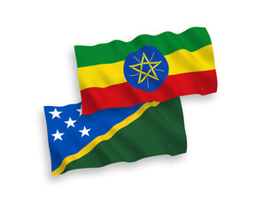 National vector fabric wave flags of Solomon Islands and Ethiopia isolated on white background. 1 to 2 proportion.