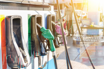 Petrol pump filling nozzles in gas station merge image with banknote and stock exchange concept