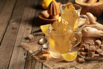 Ginger tea with ingredients on an old wooden table.
