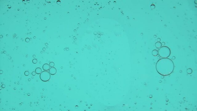 Oil bubbles streaks in slow motion, gradient lighting, macro